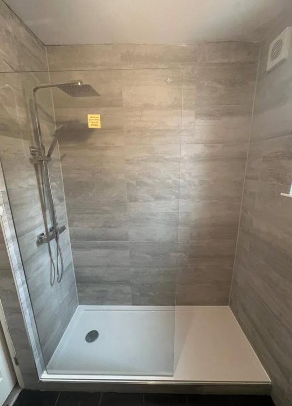 Walk-in shower conversion with grey tiling
